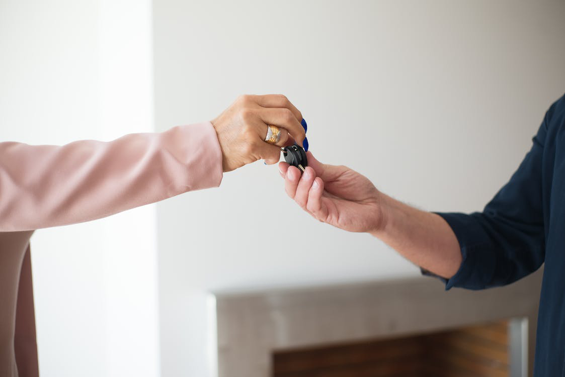 a locksmith handing over replacement keys to a person