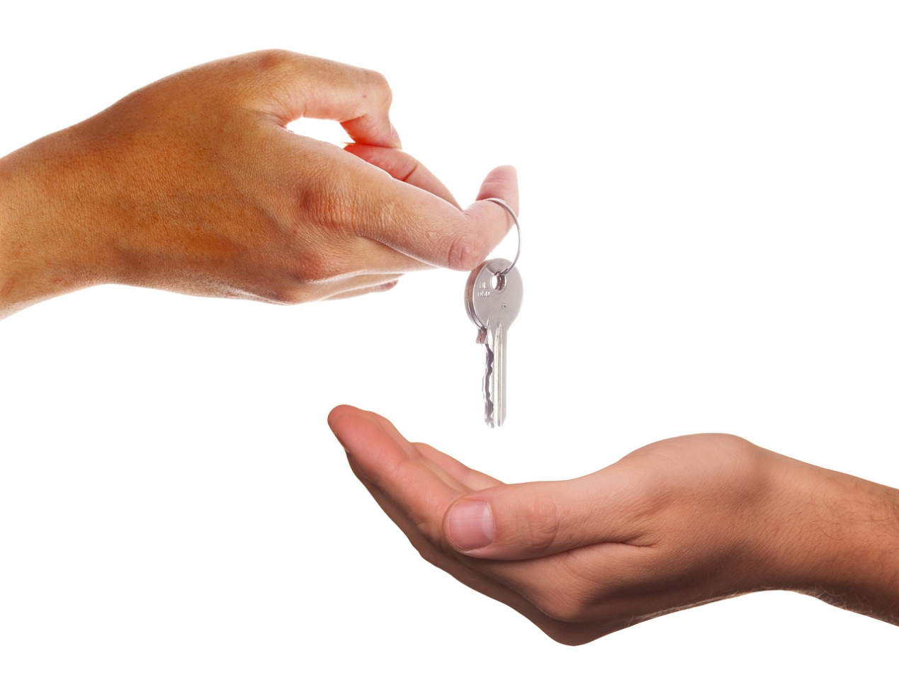 A Professional locksmith handing over a set of keys to a relieved client after resolving a lockout