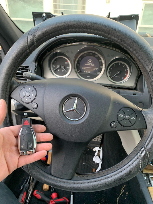 Person holding a newly replaced car key after locksmith service.